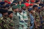 Commonwealth troops wait on Thursday to receive commemorative coins during a military parade in Pirbright, England, for representatives of the Commonwealth taking part in the coronation of King Charles III.