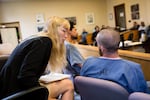 Kacy Jones speaks with a client during a hearing at Multnomah County Courthouse in Portland, Ore., Friday, May 17, 2019. Jones is an attorney with the nonprofit Metropolitan Public Defenders. She has 200 clients and is responsible for making sure they make it to court.