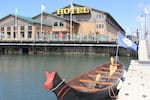 A canoe sporting a Confederated Tribes of Coos, Lower Umpqua & Siuslaw Indians flag sits in the bay at the Ko-Kwel Casino Resort.
