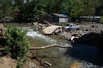 Damage to homes and vehicles along with evidence of re-routed streams can be seen on October 2, 2024 in Black Mountain, North Carolina. The road can be seen washed out from flood waters in front of his property. According to reports, at least 160 people have been killed across the southeastern U.S., and more than a million are without power due to the storm. The White House has approved disaster declarations in multiple southern states, freeing up federal emergency management money and resources.