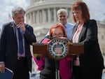 Democratic Sen. Sherrod Brown of Ohio (left) and Republican Sen. Bill Cassidy of Louisiana (in back) listen to Emily Demko and her mother, Margaret Demko, outside the U.S. Capitol last summer during a press conference on reforming the SSI program.