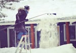 Raking snow off the roof in Bend.