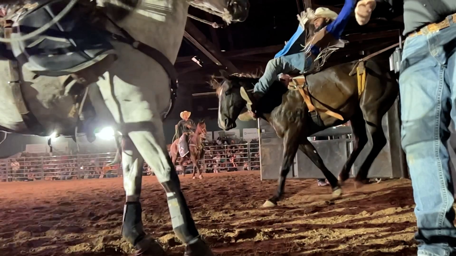 A cowboy rides a bucking bronco in front of a packed house at Portland's first Eight Seconds Juneteenth Rodeo, June 17, 2023.