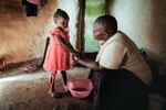 Isabela Oside, 45, washes hands of her daughter Faith, 3, who completed doses through the worlds first malaria vaccine. Malaria is one of the preventable diseases that contributes to worldwide child mortality.