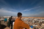 People look out from a rooftop last week as displaced Palestinians who fled Khan Younis in the southern Gaza Strip set up camp in Rafah, farther south, near Gaza's border with Egypt.