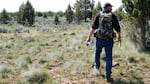 Troy Capps carries deer antlers he found in Central Oregon.