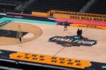 Workers make final preparations around the Men's NCAA Final Four college basketball court at the Alamodome, Monday in San Antonio. The men tip-off on Saturday. The Women's Final Four tournament, played in Atlanta, begins on Friday.