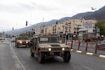 Israeli Army vehicles move in the city following a ceasefire agreement on November 27, 2024. Israeli Prime Minister Benjamin Netanyahu made a statement on Tuesday, confirming that the Israeli security cabinet approved a ceasefire agreement with Hezbollah, the Iran-backed Lebanese militant group.
