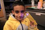 Samuel Figueroa, 10, shows off an LED light he wired at the Multnomah County Library's Rockwood branch.