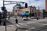 FILE - Pedestrians cross the street at the intersection of Washington and 5th in Hoboken, N.J., Thursday, Feb. 22, 2024. The city hasn't logged a single traffic death over the past nine years.