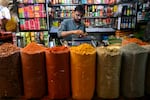 A shopkeeper sells spices at a market in Karachi on June 10, 2025.