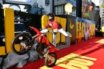 A stunt performer at the Los Angeles premiere of The Fall Guy. Outside the Dolby Theatre, another stunt artist jumped from atop a 45-foot crane, while others showed off a staged fight scene.