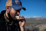 Sammy Castonguay nibbles a rock to measure its grain size.