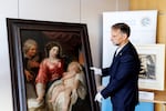 Patrick Haggenmueller, head of the Art Investigation Unit of the Bavarian State Criminal Police Office (BLKA), stands next to the fake painting Mary with Child supposedly by Flemish painter Anthony van Dyck.