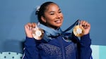 Jordan Chiles, of the United States, holds up her medals after the women's artistic gymnastics individual apparatus finals Bercy Arena at the 2024 Summer Olympics, Monday, Aug. 5, 2024, in Paris, France.