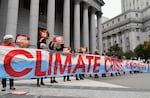 Climate activists protest on the first day of an ExxonMobil trial outside the New York State Supreme Court building in 2019 in New York City. Justice Barry Ostrager of the New York State Supreme Court ultimately found that the New York Attorney General's Office failed to prove that ExxonMobil broke the law.