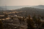 A firetruck drives on a road off of Highway 26 between Warm Springs and Madras, Ore., among acres of land burned by the Bench Fire on July 27, 2026.