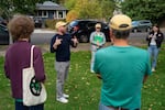 Green, left, talks with the team before they begin.