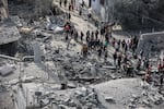 Palestinians inspect their destroyed homes after an Israeli air strike killed more than 60 people in Rafah, southern Gaza Strip, Feb. 12.