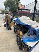 Fable Idris helps his friends assemble a "wagon train" of possessions, as they stay ahead of an encampment sweep by city workers south of Market Street.