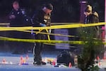 U.S. Secret Service Police examine and photograph evidence at a crime scene near the White House, Saturday, May 23, 2026, in Washington. The U.S. Secret Service shot a person near the White House on Saturday, and a bystander also was shot, a law enforcement official said.