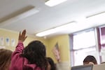 A girl raises her hand during class at Earl Boyles Elementary in Portland, March 31, 2016.