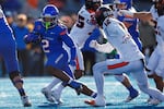 Boise State running back Ashton Jeanty (2) tackles Oregon State defensive back Tyrice Ivy Jr. (12) during the first half of an NCAA college football game on Friday, Nov. 29, 2024, in Boise, Idaho .