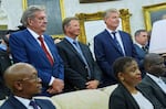 Standing from left, South African businessman Johann Rupert and golfers Retief Goosen and Ernie Els look on as President Trump meets South African President Cyril Ramaphosa in the Oval Office of the White House on Wednesday.