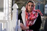 Haseena Niazi, a 24-year-old from Afghanistan, poses outside her home, Friday, Dec. 17, 2021, north of Boston. Niazi received a letter from the federal government denying her fiancé's humanitarian parole application earlier in the month. Her fiance, who she asked not to be named over concerns about his safety, had received threats from Taliban members for working on women's health issues at a hospital north of Kabul.
