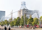 Firefighters and other emergency personnel monitor and battle a fire at a vacant warehouse in Northwest Portland, Ore., on Aug. 2, 2026.
