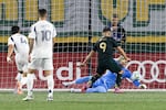 Portland Timbers forward Felipe Mora, middle, scores a goal against Real Salt Lake during the first half of an MLS soccer match Wednesday, Oct. 22, 2025, in Portland, Ore.
