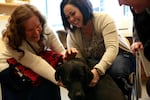 Leonard with his owner, Schalee lodge (left) and his puppy raiser Ronny Hansen (right).