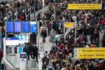 People wait in a TSA line at the John F. Kennedy International Airport, Sunday, March 22, 2026, in New York.