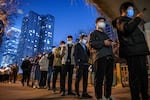 China is doing many millions of tests a day to uncover cases of COVID-19 — part of its zero-COVID policy. Above: People line up for nucleic acid tests to detect the virus at a public testing site on Nov. 17 in Beijing.