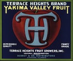 A label with a graphic of the letters "TH" in front of an apple on a blue background with a green frame.