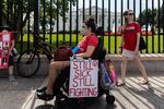 Protesters march outside the White House to call attention to those who have long COVID.