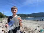 Orcas Island Middle School seventh grader Paxton Erwin holds a European green crab molt he found on the island's Crescent Beach in May 2026.