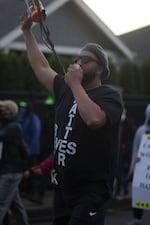 Isiah Wagoner shouts into the bullhorn at a protest march against police brutality in Eugene, Ore.