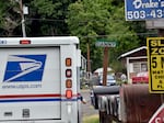 Early on her route, Connie Gunn delivers mail in a mobile home community in Scappoose, Ore.
