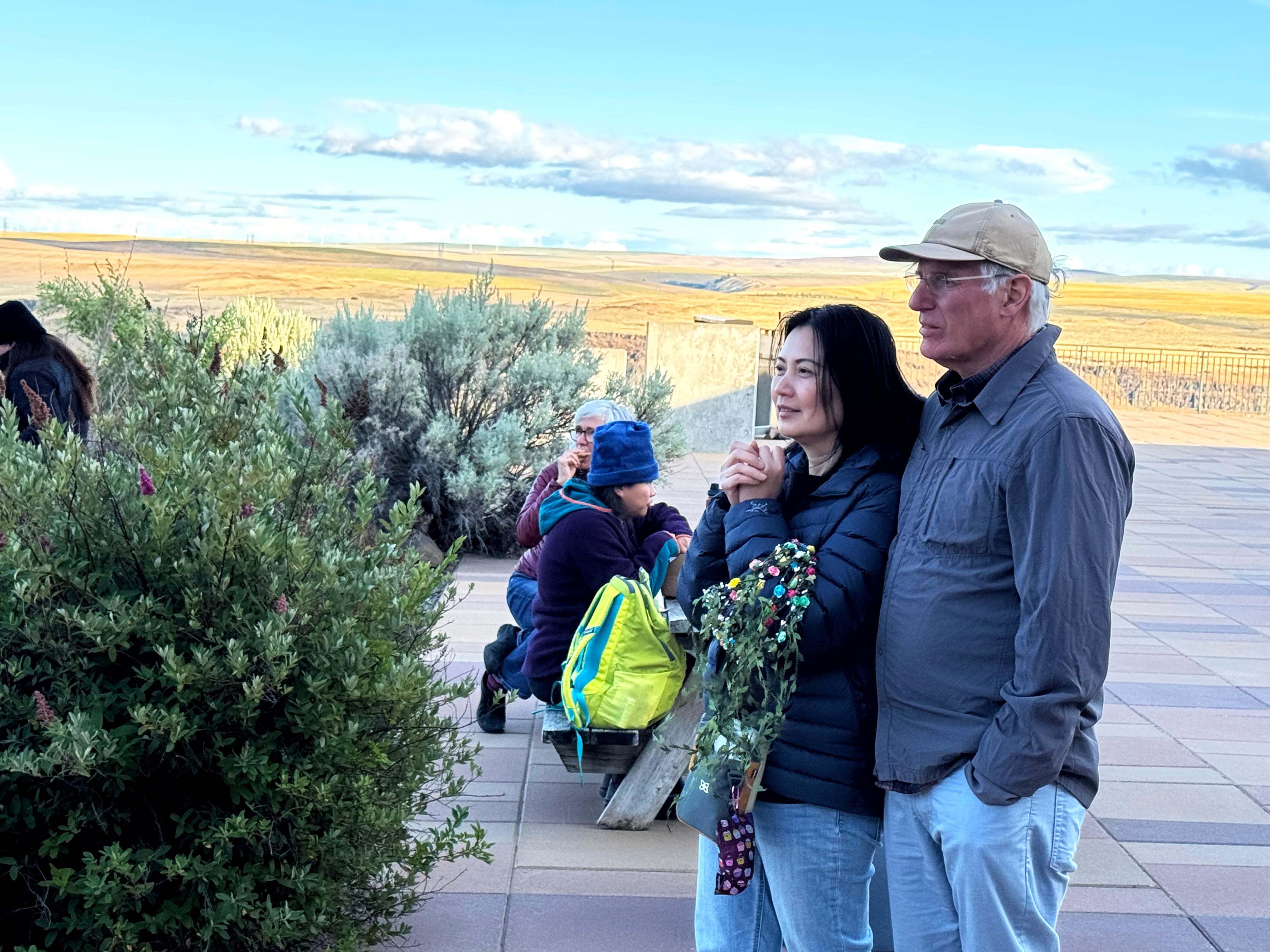 David Lee and his wife, Eka Lee, watch a guitar performance on the evening of June 20, 2025, before an early morning solstice celebration the day after. Lee organized the event, which included storytelling and yoga on the grounds of Maryhill Museum of Art.