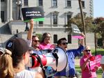Over two dozen abortion rights supporters attend a rally outside the South Carolina State House in Columbia, S.C., on Wednesday, Aug. 23, 2023. The South Carolina Supreme Court ruled to uphold a law banning most abortions except in the earliest weeks of pregnancy.