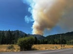 Smoke rises from the Evans Creek Road Fire northeast of Rogue River on Friday, July 10, 2026.