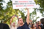A demonstrator holds a banner as teachers, students and their sympathisers protest in central Budapest at the headquarters of the Interior Ministry on September 2, 2024, after the head of the renowned Madach Imre high school was sacked last week for not implementing a government-mandated "smartphone ban". In August, schools were instructed to collect students' phones and smart devices during the teaching hours in a decree signed by nationalist Prime Minister Viktor Orban. The principal of the Madach Imre High School was fired, after it refused to implement the ban, citing a part of the regulation.