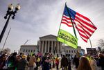 Demonstrators protest and argue outside the U.S. Supreme Court.
