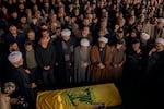 Muslim clerics, relatives and friends mourn the death of Khadija Salman in Majdal Zoun, on Feb. 22. A Hezbollah flag covers the coffin, in a region of Lebanon where support for the militia is strong.