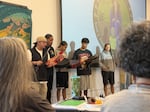 Members of the Chief Kitsap Academy Song and Dance Group welcome educators and neighbors of the Suquamish Tribe to the preview of the Suquamish Since Time Immemorial Curriculum on Aug. 19, 2026.