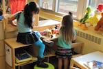 Preschoolers working together on a puzzle (file photo).