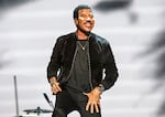 Lionel Richie performs on a stage.
