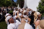 Costaleros (men who carry floats bearing the statue of Christ or the Virgin) of La Paz brotherhood wait before taking part in a procession during Holy Week (Semana Santa) observances on March 29, 2026 in Seville, Spain.