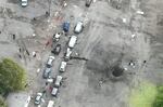 In this image released by the Ukrainian Police Press Service, the view from a drone shows the site of a Russian rocket attack in Zaporizhzhia on Friday. A Russian strike on the Ukrainian city killed at least 23 people and wounded dozens, an official said Friday, just hours before Moscow planned to annex more of Ukraine in an escalation of the seven-month war.
